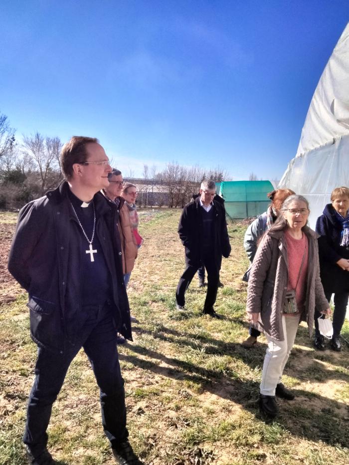 Mgr Luc Meyer en visite sur la paroisse. Ici aux Jardins de la solidarité à Cassagnes - Bégonhès.